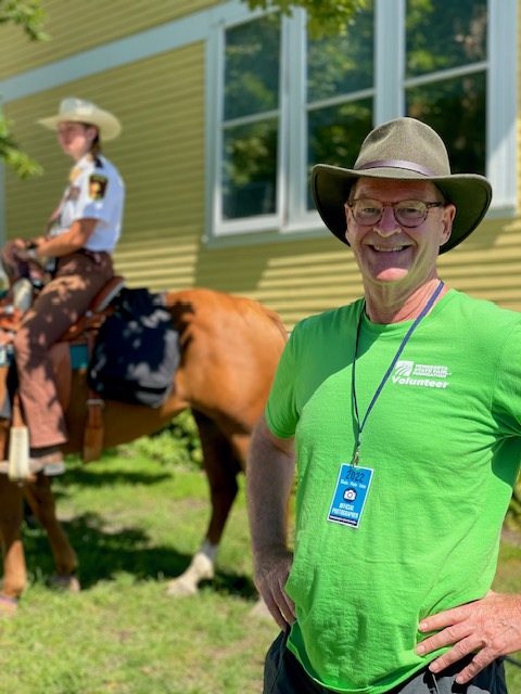 Dale Raduenz, MSF Foundation donor, poses in a Foundation Volunteer t-shirt in front of the J.V. Bailey House